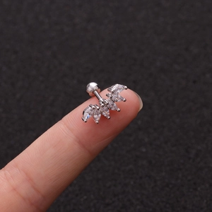 Detailed view of silver titanium steel ear stud with marquise-cut zircons on a finger