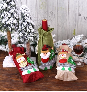Detail of burlap Christmas wine bottle covers with 3D Santa and snowman dolls