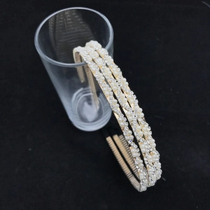 Detailed macro view of triple-layered pearl headband with crystals on gold frame