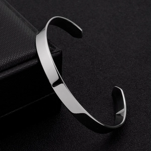 Polished silver C-shaped titanium steel open cuff bracelet on black jewelry box
