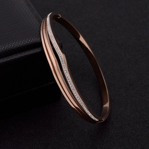 Detailed close-up of rose gold titanium steel bracelet with sparkling white rhinestones