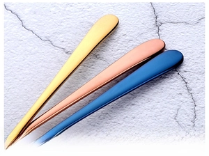 Close-up of food grade stainless steel fork handles in gold, rose gold and blue plating