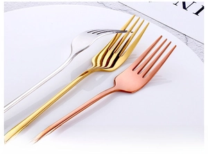 Macro detail of polished silver, gold, and rose gold stainless steel dinner forks