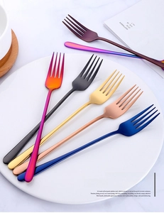 Macro shot of colorful stainless steel long-handle forks in various metallic finishes