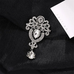 Vintage silver tiara crown brooch with sparkling pear-shaped rhinestones on black fabric