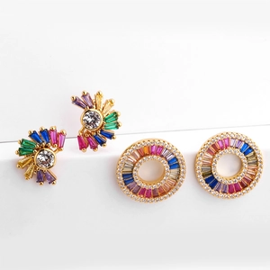 Detailed macro view of gold plated earrings featuring rainbow zircon stones and crystals