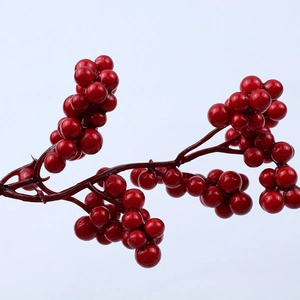 Close-up of vibrant red artificial berries with glossy finish for Christmas home decor