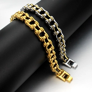 Close-up of gold and silver stainless steel motorcycle chain bracelets for men