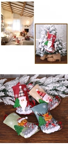 Detail of burlap Christmas stockings with Santa and reindeer applique for tree hanging