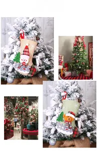 Detail of burlap Christmas stockings with plaid snowman and bear motifs on a tree