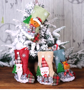 Set of four burlap Christmas stockings with 3D Santa, Bear, Snowman and Reindeer figurines