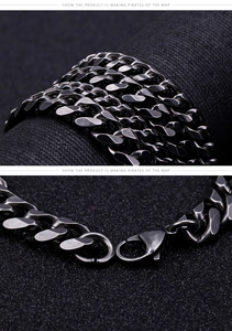 Detail of dark gunmetal Cuban link bracelet with lobster clasp on black background
