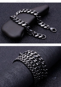Close-up of matte black Cuban link bracelet with lobster clasp on a dark textured background