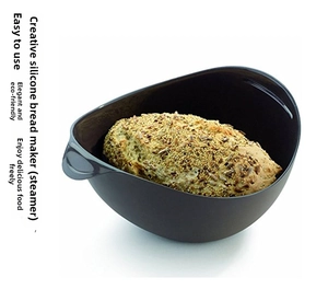 Macro view of dark grey silicone bread maker with baked bread and seeds inside
