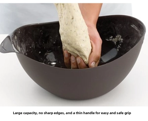 Detail of a large brown silicone steamer bowl with ergonomic handles for dough kneading