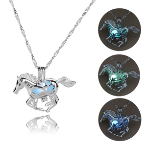 Luminous galloping horse necklace pendant glowing in blue and green in dark environments