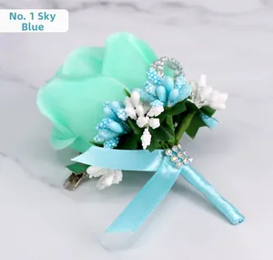 Detail of sky blue fabric rose boutonniere with metal clip on marble background