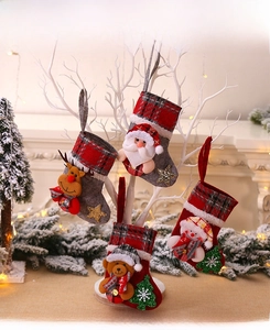 Detail of four plaid Christmas stockings with 3D Santa, Snowman, Bear, and Reindeer icons