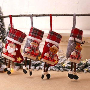 Set of four plaid Christmas stockings with Santa, Snowman, Bear, and Reindeer decorations