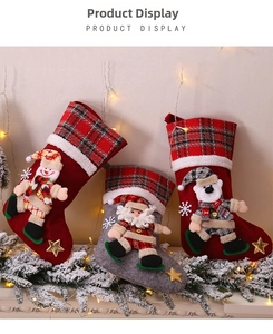 Detailed view of 3D snowman, santa and bear plush figures on red plaid Christmas stockings