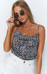 Detail view of navy blue floral camisole featuring delicate cowl neck and daisy print