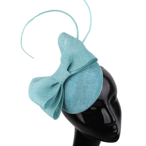 Detail of turquoise vintage fascinator hat featuring handmade bow and textured weaving