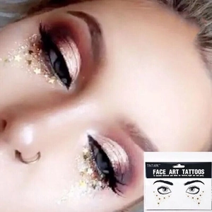 Detailed view of Tintark gold star face tattoos for eyes and festive party makeup