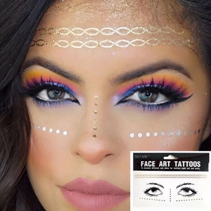 Detail of metallic gold and silver face art tattoos for festive makeup looks