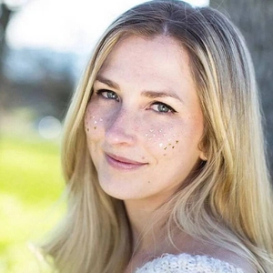 Waterproof gold heart face stickers for makeup on a model’s cheeks and nose