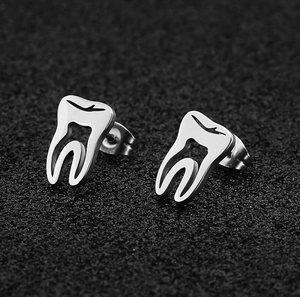 Polished silver molar tooth stud earrings with anatomical engraving on black background