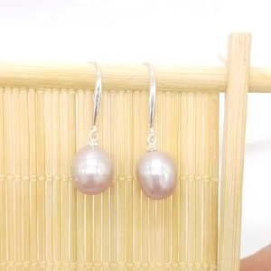 Macro detail of natural lavender freshwater pearl drop earrings with S925 silver hooks