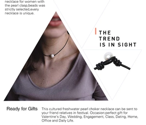 Detail shot of the freshwater pearl closure on a stylish black leather cord necklace