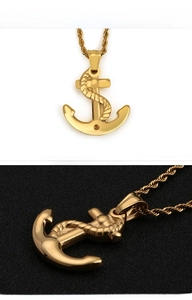 Detailed view of a gold anchor pendant necklace with rope texture and twisted chain