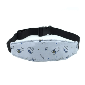 Detail of baby safety head support strap with blue cartoon patterns and plastic buckle