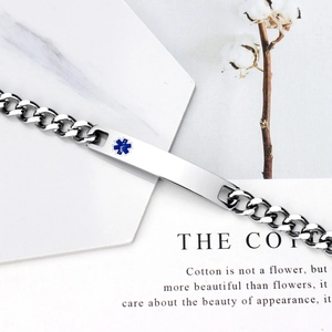 Polished stainless steel medical alert bracelet with blue Star of Life on marble card