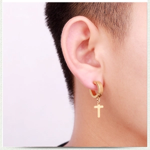 Golden stainless steel hoop earrings with cross pendant shown worn on ear for women and men