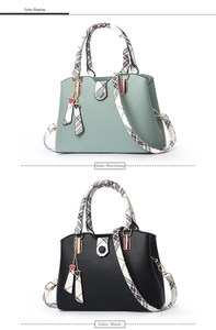 Detail view of jasmine green and black large tote bags with plaid handles and heart charms