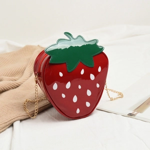 Cute strawberry-shaped crossbody bag in red patent leather with a gold chain strap