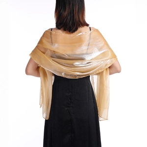 Elegant gold translucent evening shawl for wedding brides over a black dress on white background