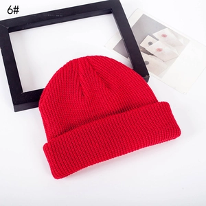 Bright red knitted beanie hat for women featuring thick knit texture and wide cuffed brim