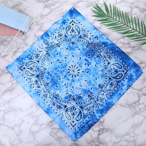 Close-up of blue paisley 100% cotton bandana showing detailed patterns on marble surface