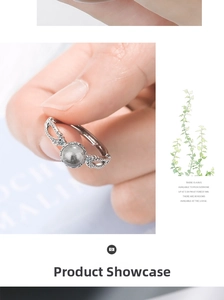 Detailed view of silver ring with round grey natural stone and wavy diamond band