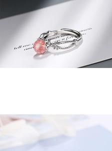 Detailed close-up of a pink strawberry quartz ring with sparkling side stones in silver