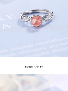 Macro view of pink strawberry crystal ring with silver interlaced hollow band detail