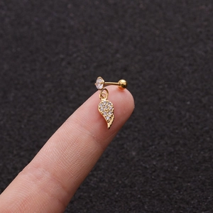 Gold stainless steel stud earring with micro-paved zircon wing pendant on finger