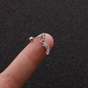 Macro shot of silver stud earring with micro-paved cubic zirconia on a curved bar