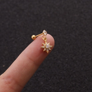 Detail of gold micro-paved zircon star pendant earring with screw ball back closure