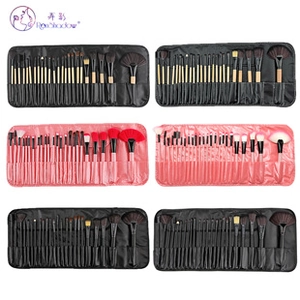 Close-up of a 32-piece makeup brush set featuring synthetic bristles and a roll-up storage pouch
