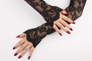 Close-up of black lace arm sleeves with floral patterns and scalloped edges