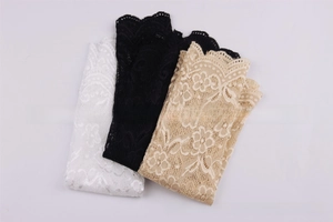 Detailed lace texture and scalloped edges of sun protection arm sleeves in white and beige